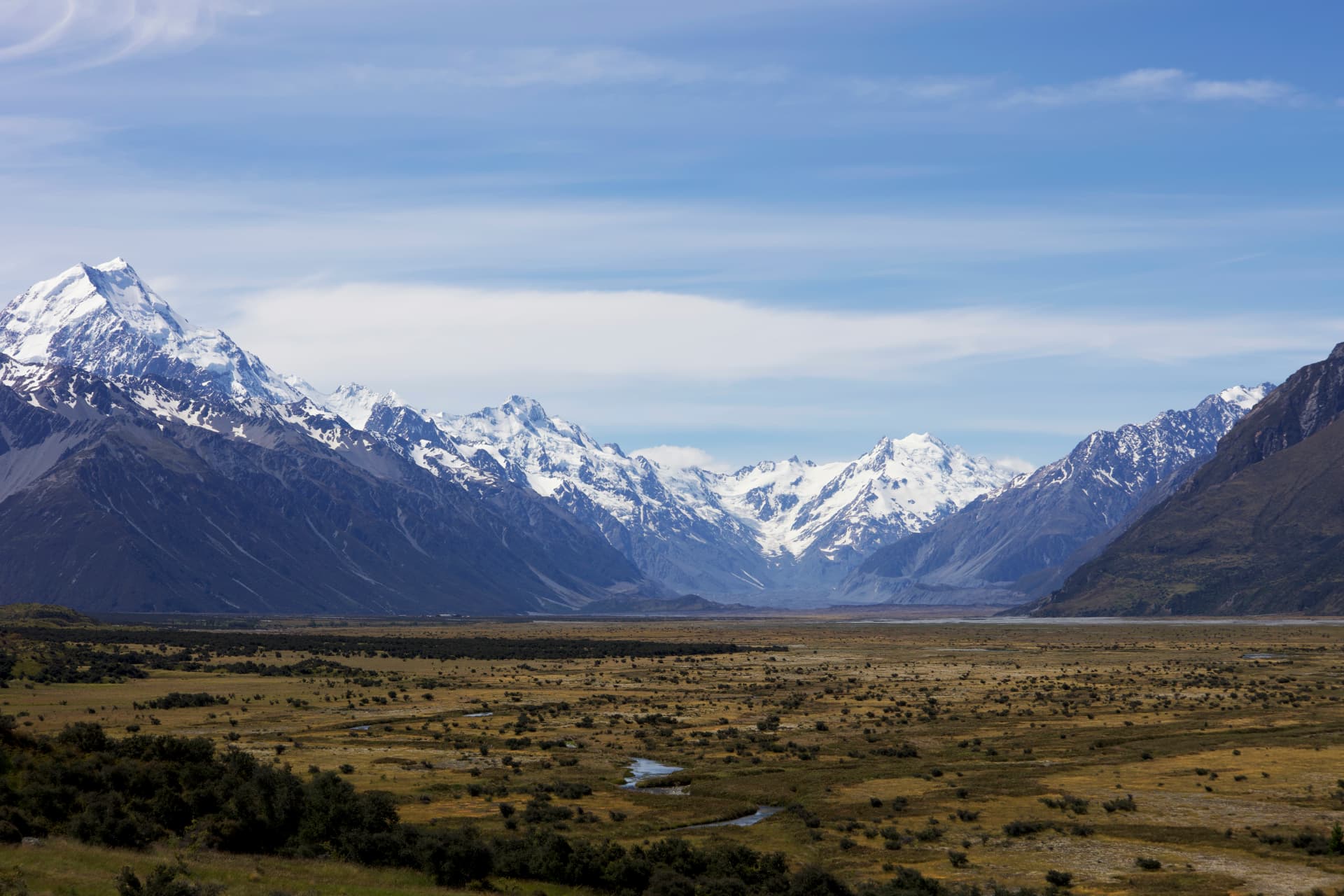 A wide valley view of the Hooker Valley with Mount Cook and the Southern Alps rising above a braided river plain, New Zealand